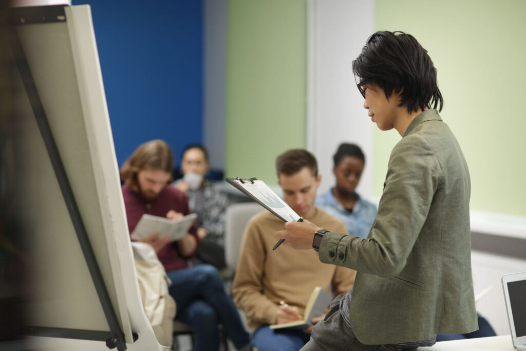 Asian teacher reading a lecture