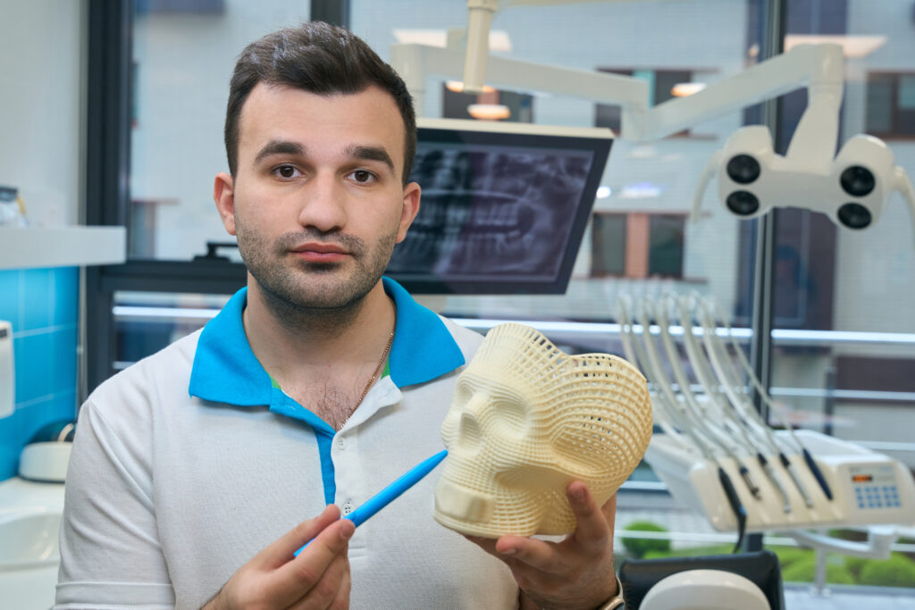 Man demonstrates a model of a human skull