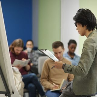 Asian teacher reading a lecture