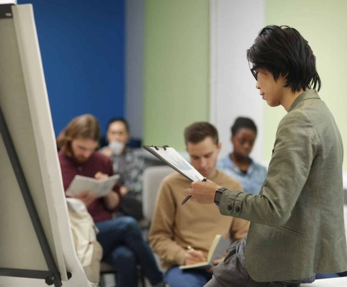 Asian teacher reading a lecture